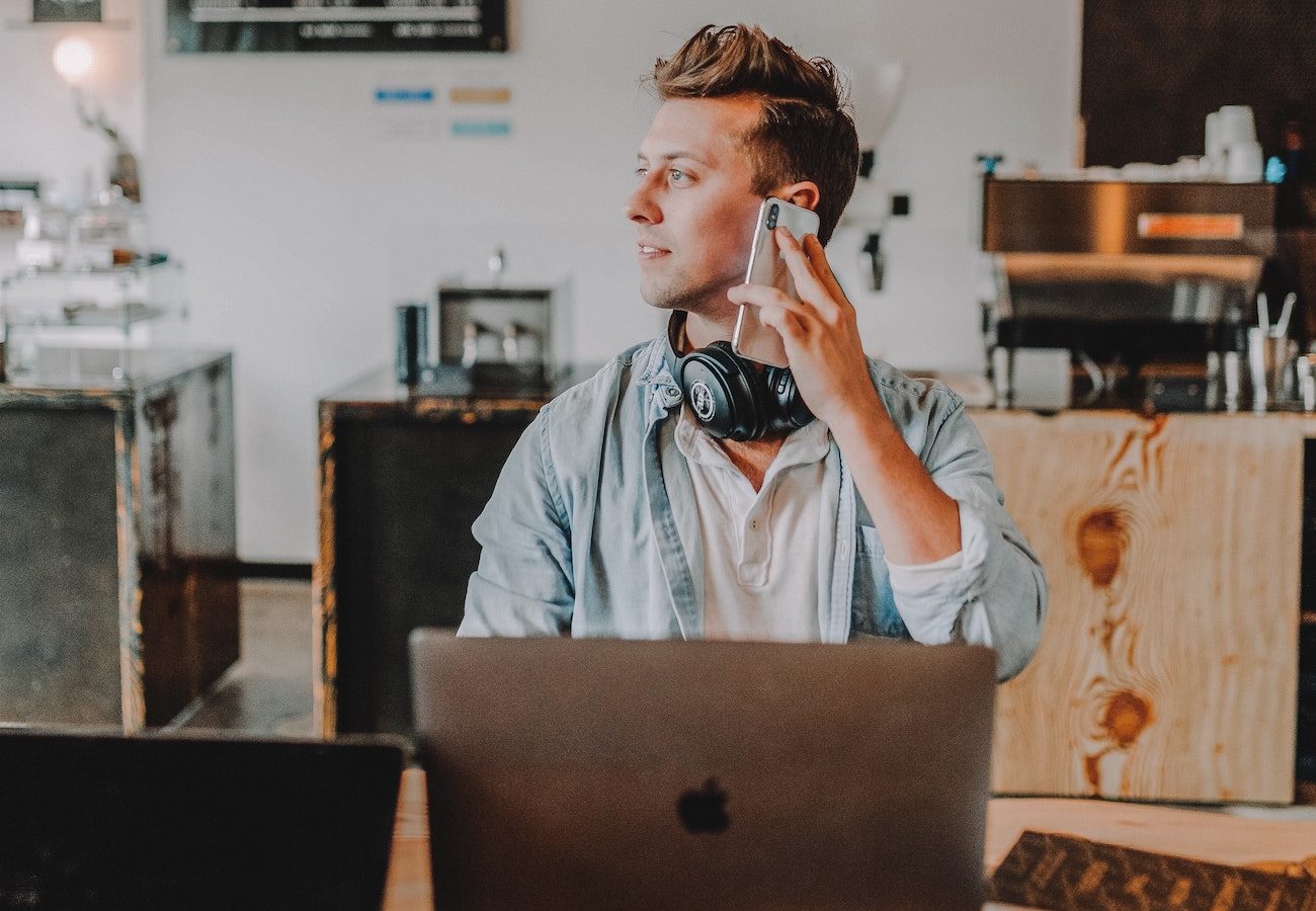 man on the phone with laptop buying extended car warranty